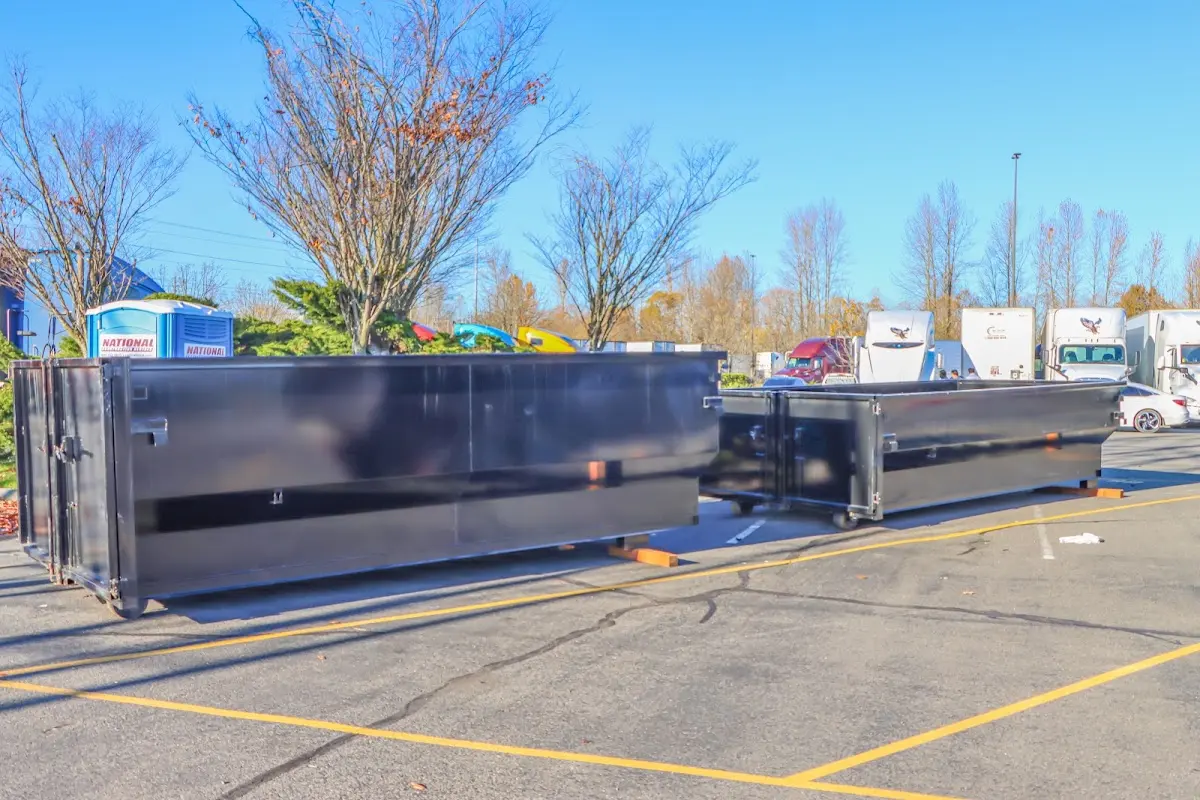 Professional dumpster rental service with roll-off container on residential driveway in Huntington Park